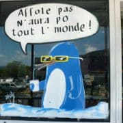 Pengin in blue Paint Markers on a Ice Cream Storefront Window in France Cohas.com